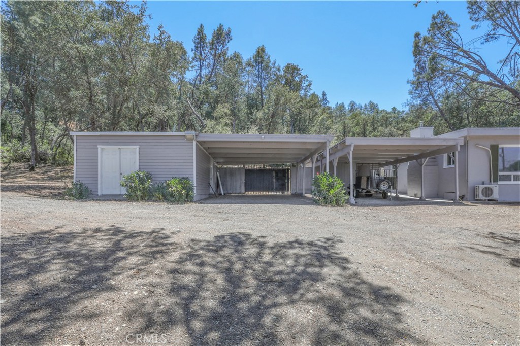 15905 Kugelman Street Lower Lake, CA 95457 - Photo 4 of 75 a front view of a house with garden and trees