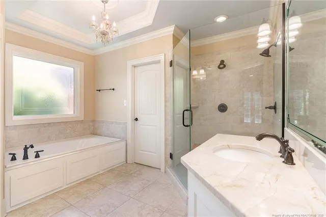 a bathroom with a granite countertop sink a toilet a mirror and shower