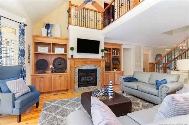 a living room with furniture a fireplace and a flat screen tv