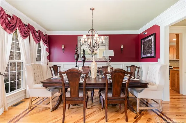 a view of a dining room with furniture and chandelier