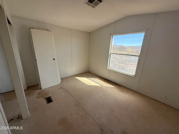 a view of an empty room and a window