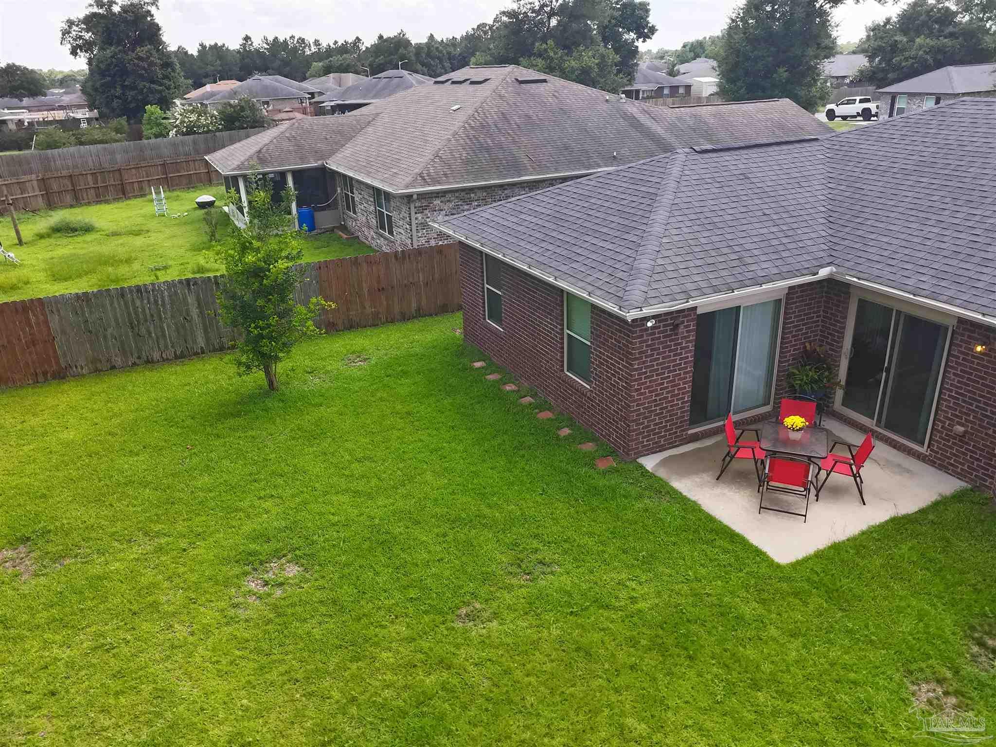 5709 Mill Stream Way Pace, FL 32571 - Photo 13 of 48 an aerial view of a house having patio with a yard