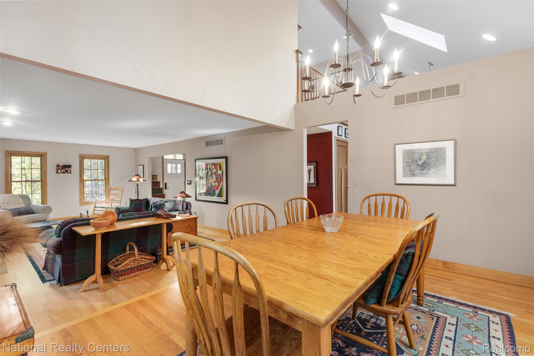 2322 Addaleen Road Highland, MI 48357 - Photo 21 of 54 Dining area with light wood-style flooring, recessed lighting, a skylight, a chandelier, and a towering ceiling