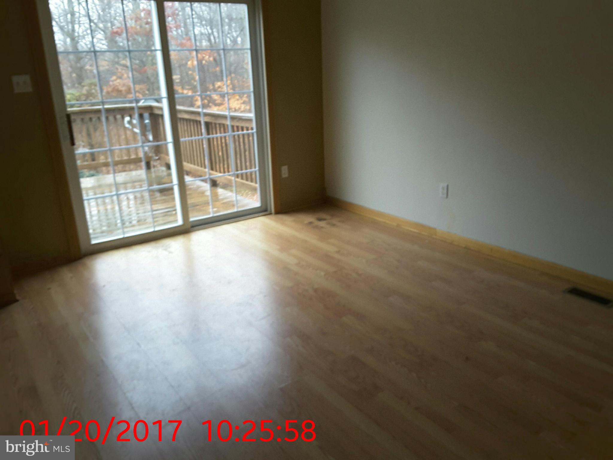 2406 Beaver Crossing Road Edgewood, MD 21040 - Photo 4 of 18 an empty room with wooden floor and windows