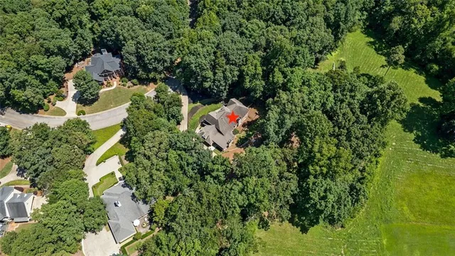 an aerial view of a house with a yard and lake view