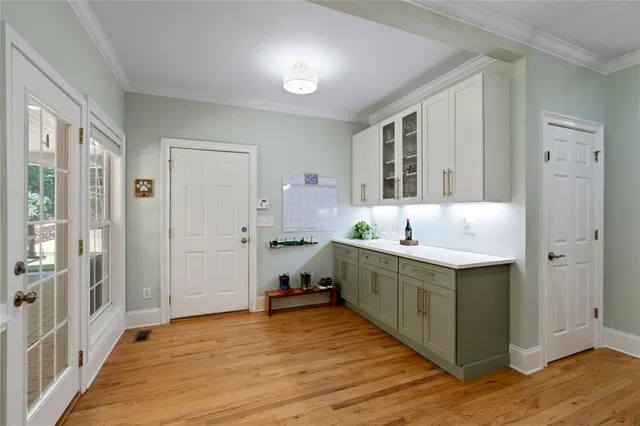 a spacious bathroom with a granite countertop sink a large mirror and a shower