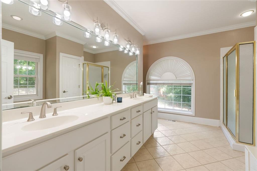 3095 Chattahoochee Trace Gainesville, GA 30506 - Photo 16 of 37 a spacious bathroom with a granite countertop sink a large mirror and a shower
