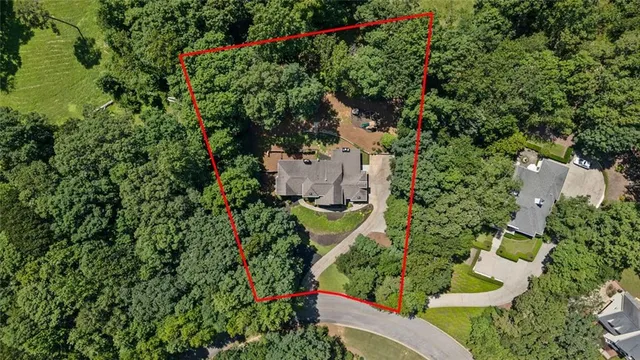 an aerial view of a house with a yard and lake view