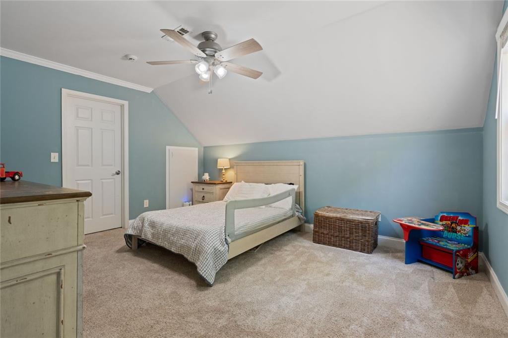 3095 Chattahoochee Trace Gainesville, GA 30506 - Photo 23 of 37 a bedroom with a bed and a chandelier