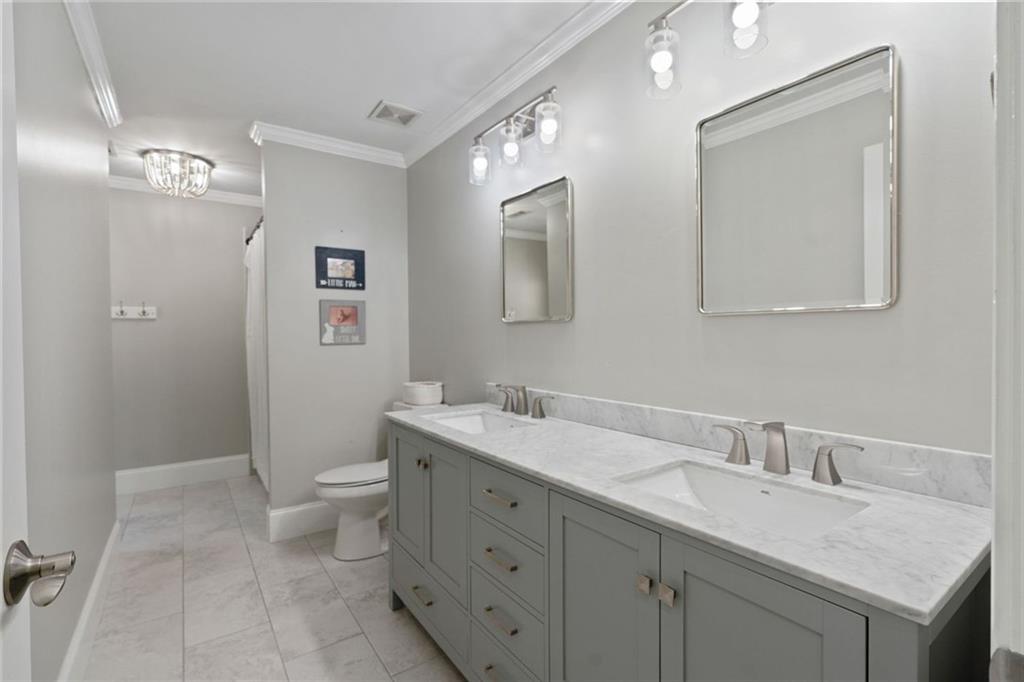 3095 Chattahoochee Trace Gainesville, GA 30506 - Photo 24 of 37 a bathroom with a toilet sink and mirror
