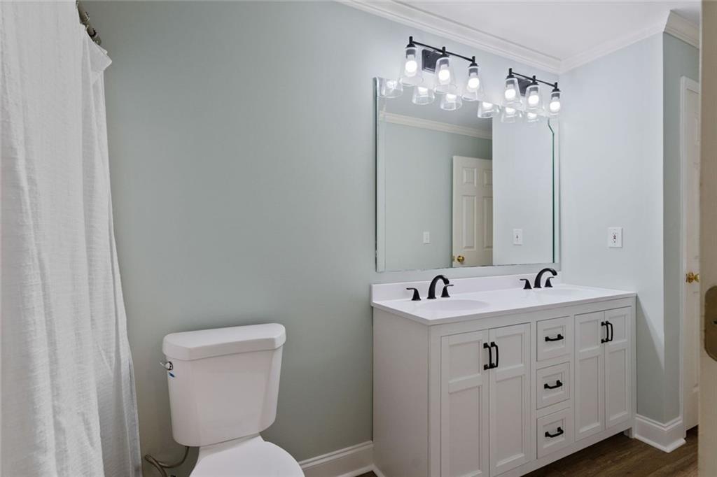 3095 Chattahoochee Trace Gainesville, GA 30506 - Photo 29 of 37 a bathroom with a sink toilet and mirror