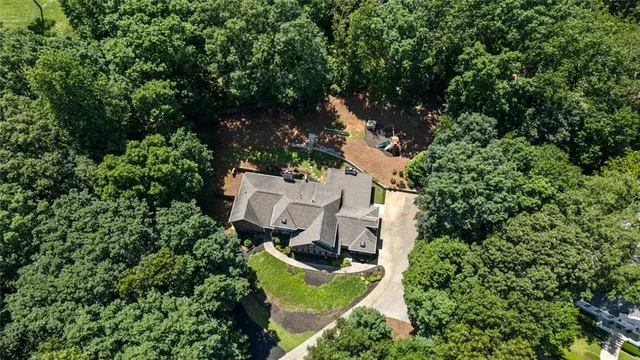 an aerial view of a house with yard swimming pool and outdoor seating