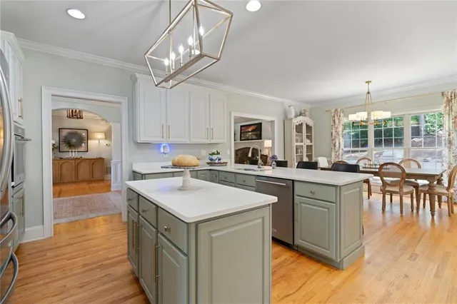 a kitchen with stainless steel appliances granite countertop a refrigerator a stove and a sink