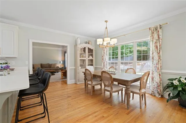 a kitchen with a sink cabinets and wooden floor