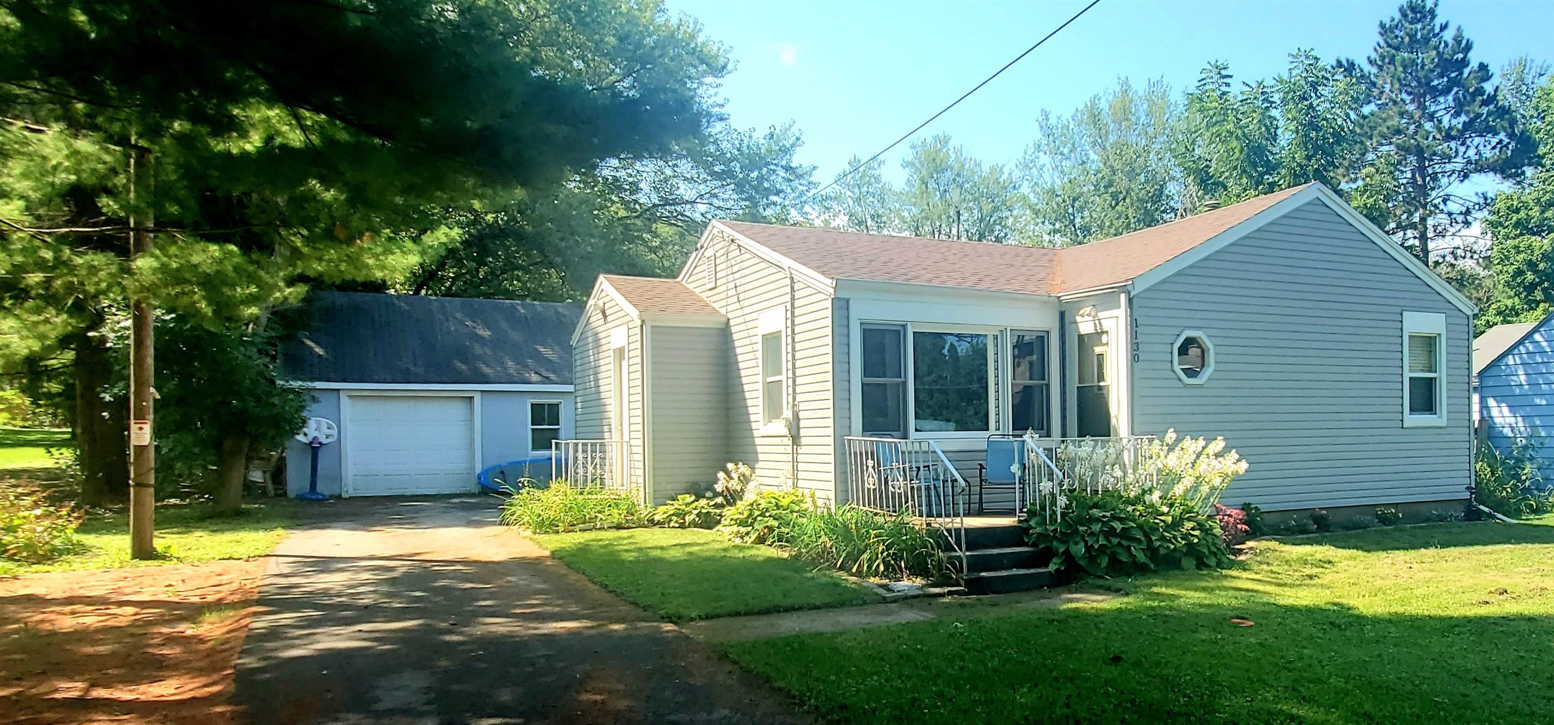 a view of a house with a yard and plants