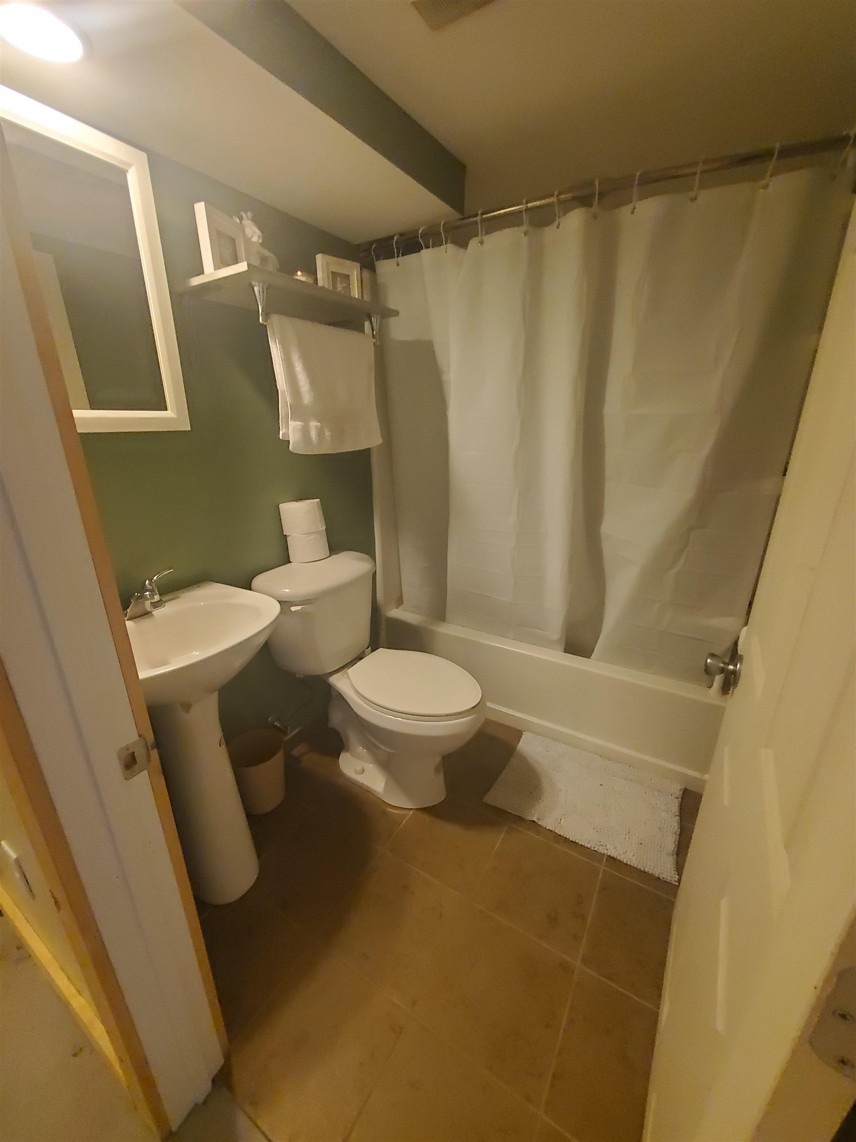 1130 Ritsher Street Beloit, WI 53511 - Photo 14 of 14 a white toilet sitting next to a bathroom sink and a shower