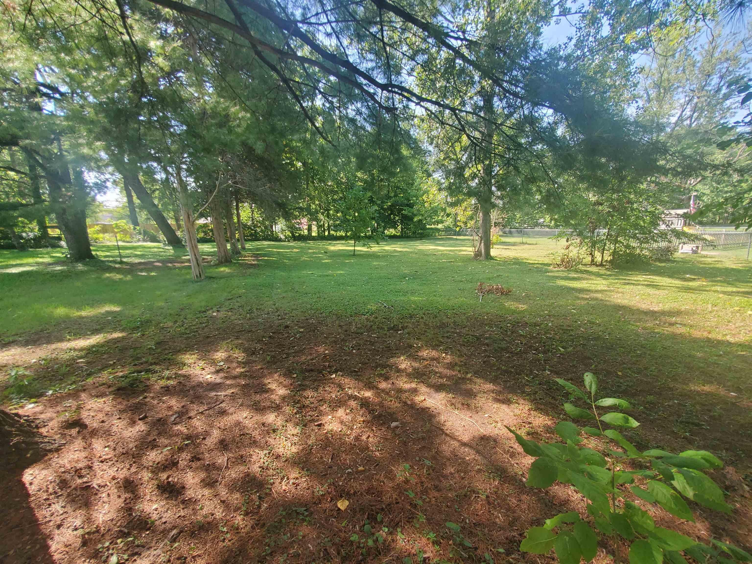 1130 Ritsher Street Beloit, WI 53511 - Photo 4 of 14 a view of a field with trees in the background