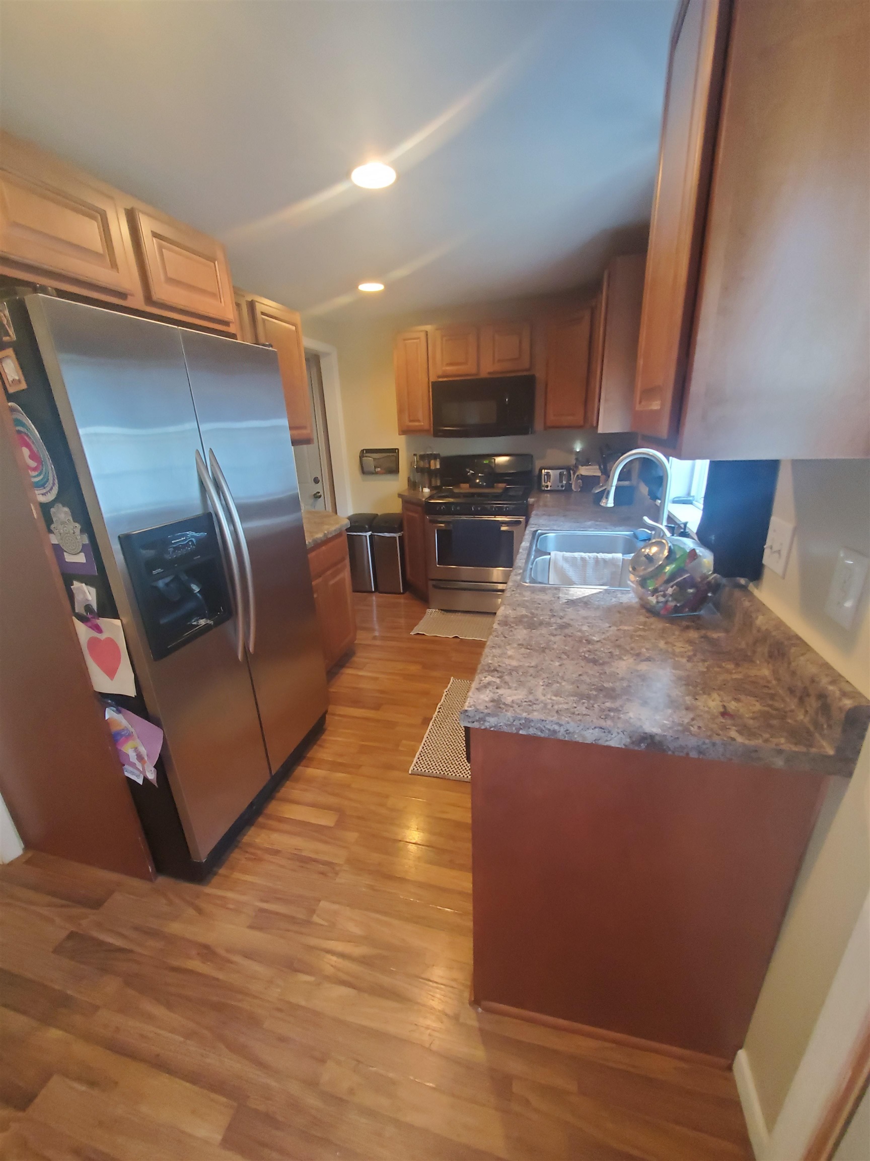 1130 Ritsher Street Beloit, WI 53511 - Photo 10 of 14 a kitchen with stainless steel appliances granite countertop a stove a sink and a refrigerator