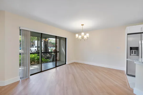 a view of kitchen with stainless steel appliances refrigerator oven and cabinets