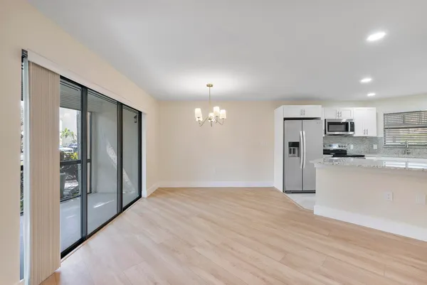 a view of an empty room and a window