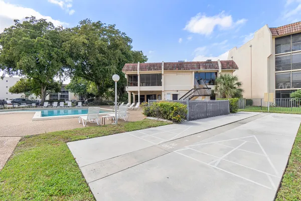 an aerial view of a house with backyard space and patio