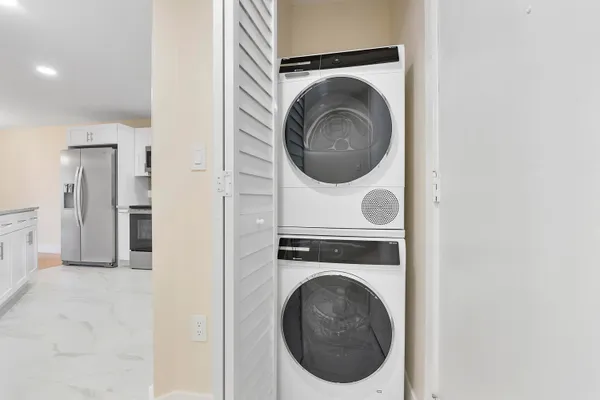 a living room with furniture and kitchen view