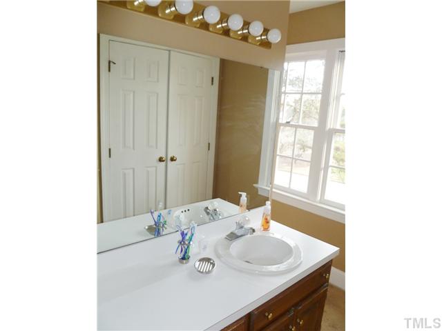 2409 Scouting Trail Raleigh, NC 27615 - Photo 11 of 22 a bathroom with a sink and a mirror