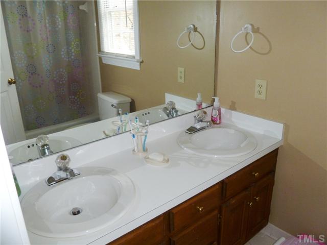 2409 Scouting Trail Raleigh, NC 27615 - Photo 15 of 22 a bathroom with a sink and a mirror