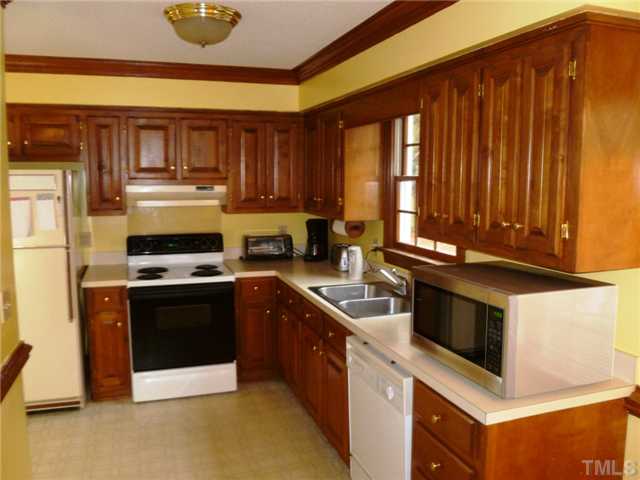 2409 Scouting Trail Raleigh, NC 27615 - Photo 5 of 22 a kitchen with stainless steel appliances granite countertop a stove a sink and a microwave