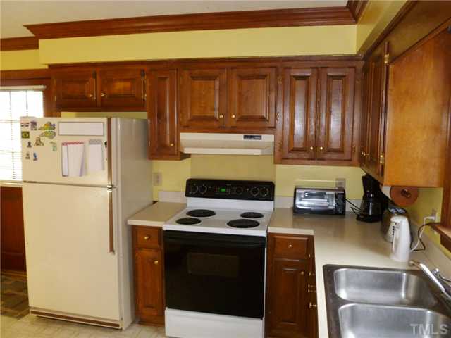 2409 Scouting Trail Raleigh, NC 27615 - Photo 6 of 22 a kitchen with a refrigerator stove and sink