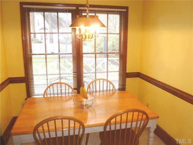 2409 Scouting Trail Raleigh, NC 27615 - Photo 8 of 22 a view of a dining room with furniture a chandelier and a window