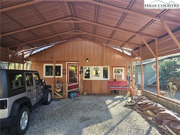 a view of a car park in front of a house
