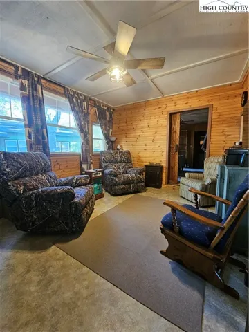 a living room with furniture gym equipment and a large window