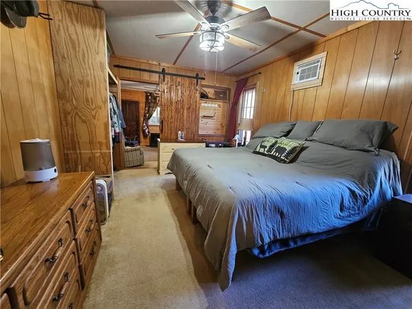 a spacious bedroom with a bed and a chandelier