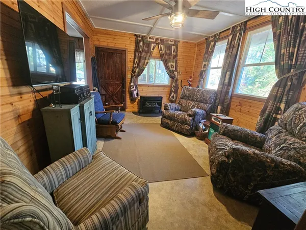 a bedroom with furniture and a flat screen tv