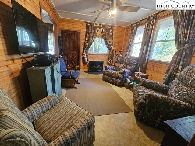 a bedroom with furniture and a flat screen tv