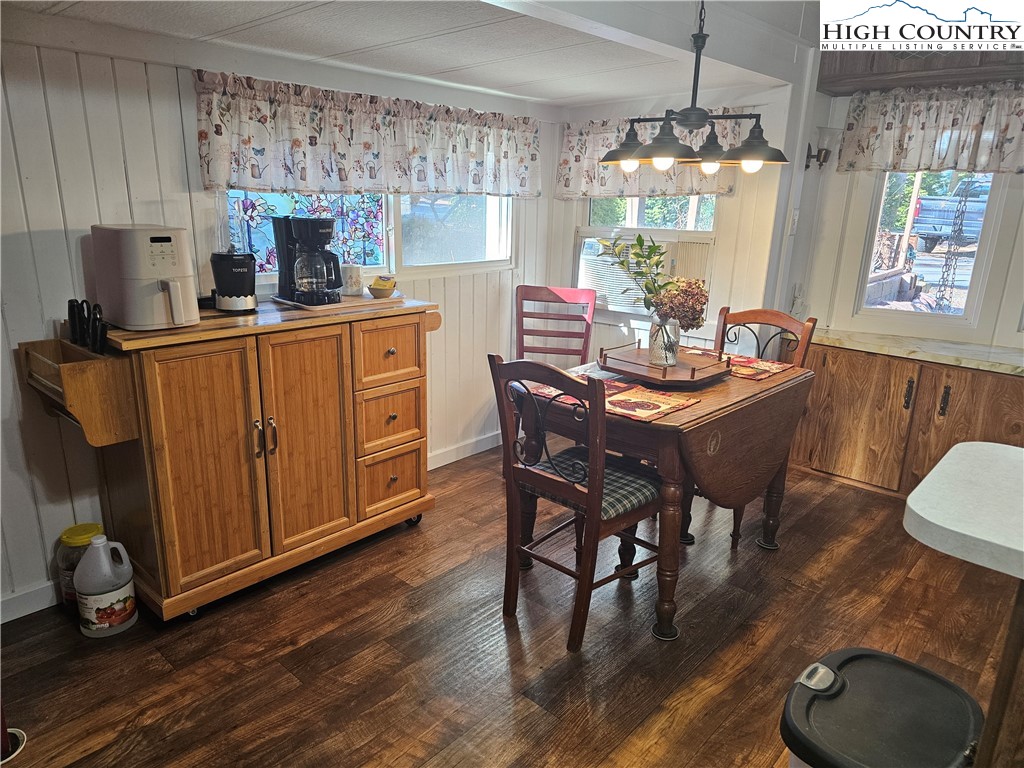 184 Trillium Road Newland, NC 28657 - Photo 10 of 15 a dining room with furniture a chandelier and wooden floor