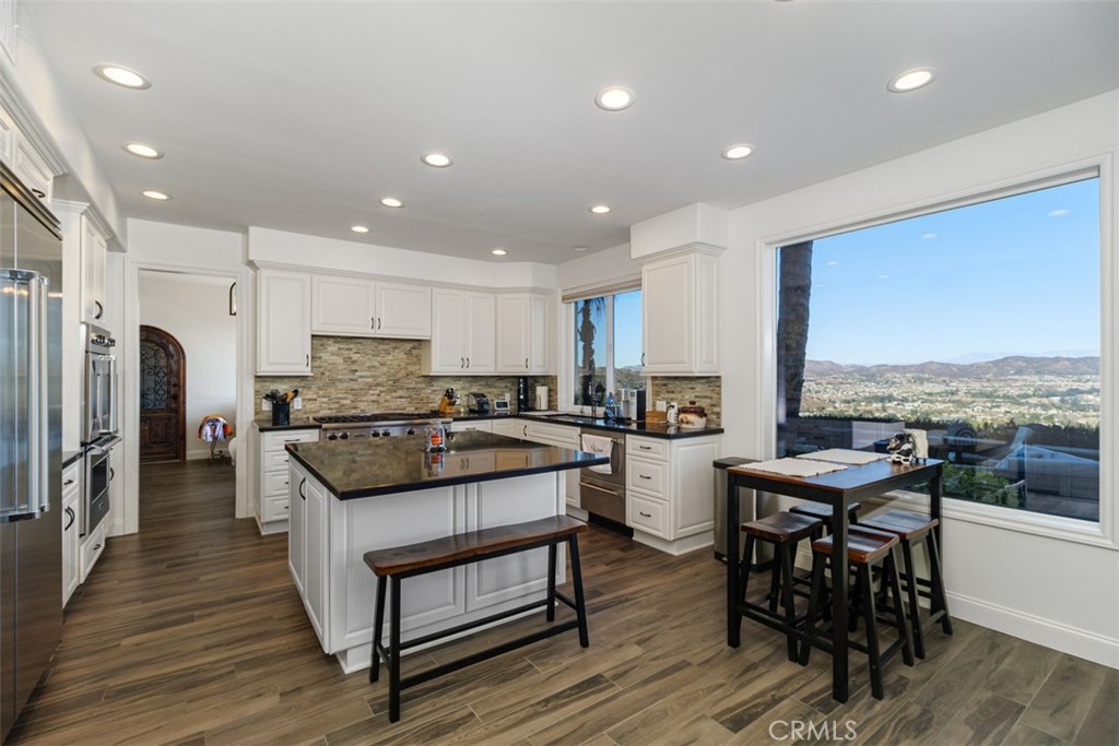 37964 Pinnacle Court Murrieta, CA 92562 - Photo 20 of 47 a kitchen with a table chairs stove and refrigerator