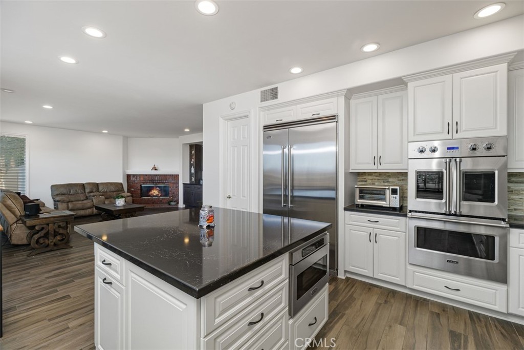 37964 Pinnacle Court Murrieta, CA 92562 - Photo 23 of 47 a kitchen with kitchen island a sink stove and refrigerator