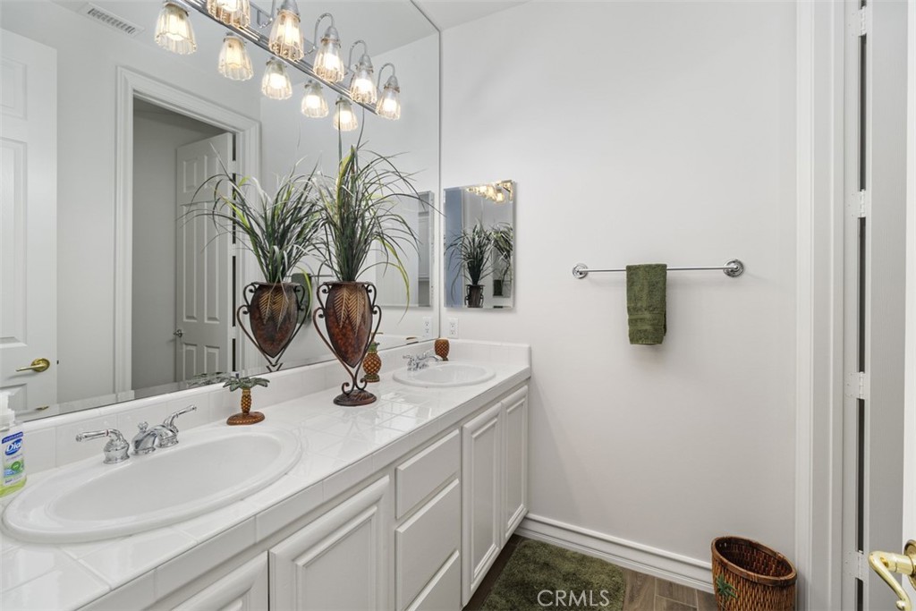 37964 Pinnacle Court Murrieta, CA 92562 - Photo 31 of 47 a bathroom with a sink a light fixture and a mirror