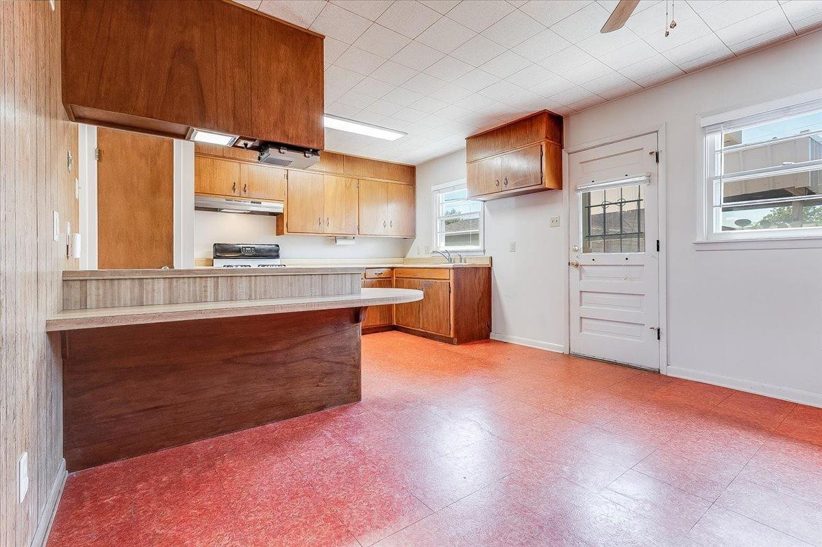 2801 62nd Street Lubbock, TX 79413 - Photo 13 of 21 a kitchen with stainless steel appliances granite countertop a stove a sink dishwasher and a refrigerator