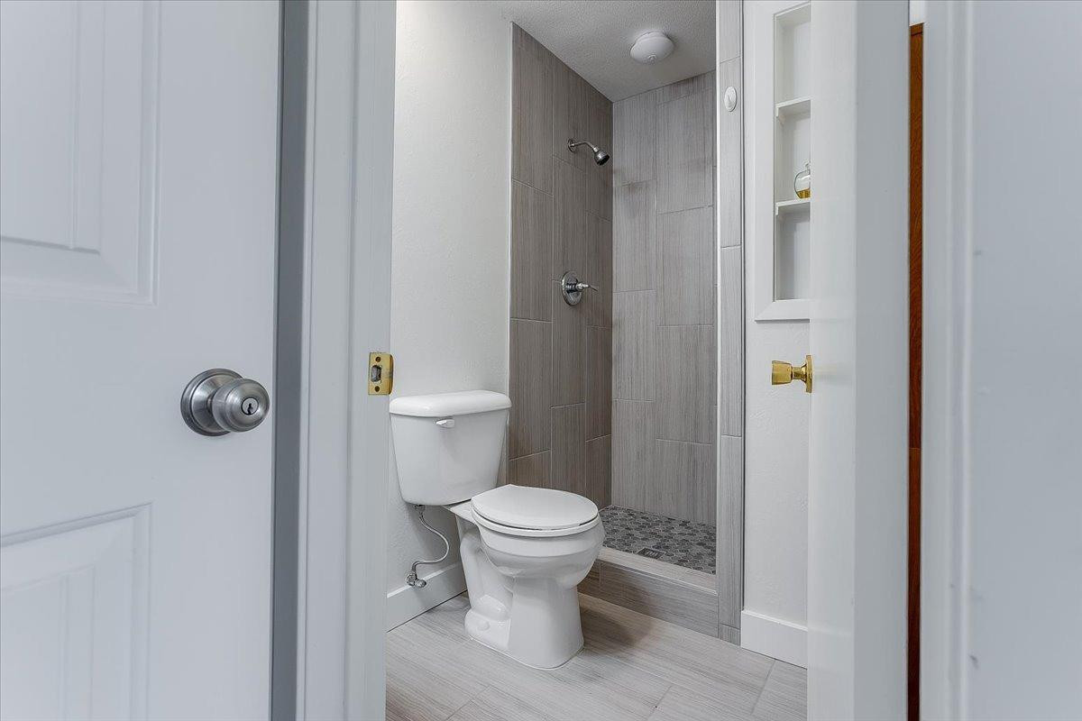 2801 62nd Street Lubbock, TX 79413 - Photo 17 of 21 a bathroom with a toilet and a shower
