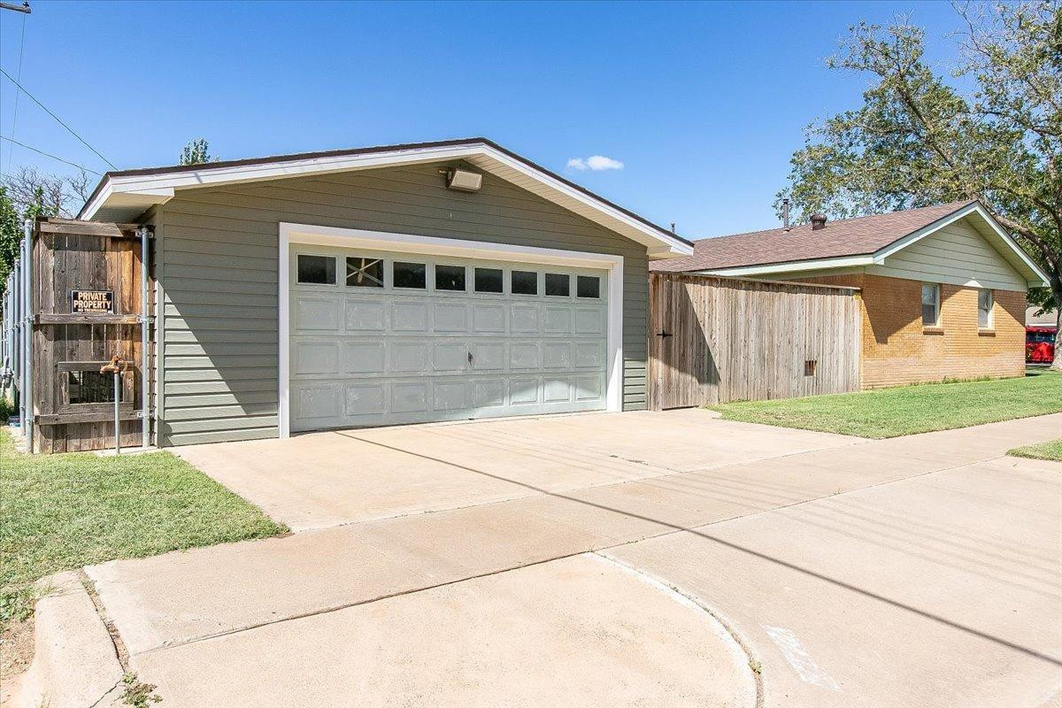 2801 62nd Street Lubbock, TX 79413 - Photo 2 of 21 a front view of a house with a yard and garage