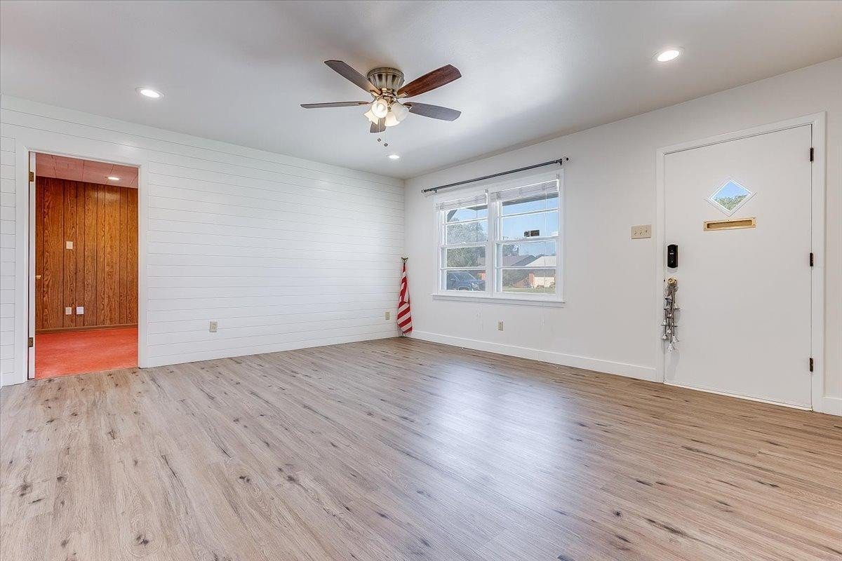 2801 62nd Street Lubbock, TX 79413 - Photo 7 of 21 an empty room with wooden floor and windows