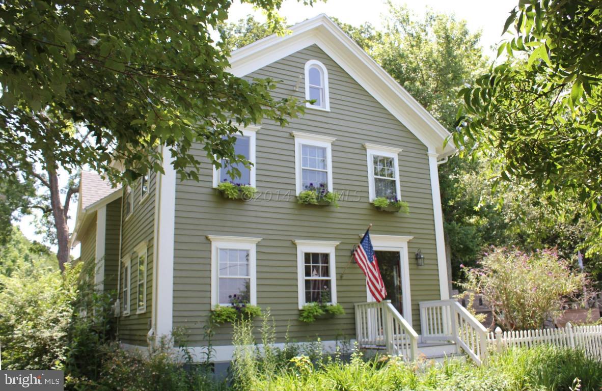 a view of a house with brick walls and plants