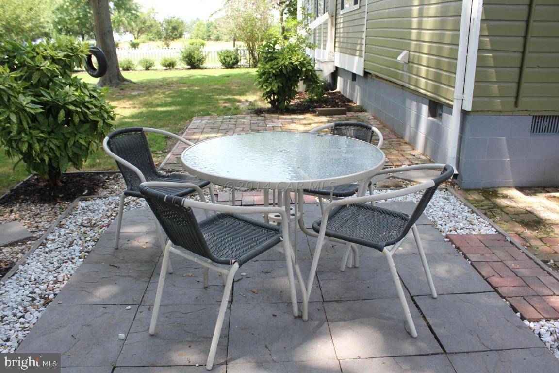 20633 Nanticoke Road Nanticoke, MD 21840 - Photo 46 of 46 a table and chairs in a patio