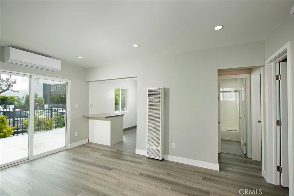 5459 Carlin Street, Unit 1 Los Angeles, CA 90016 - Photo 13 of 22 an empty room with wooden floor and windows