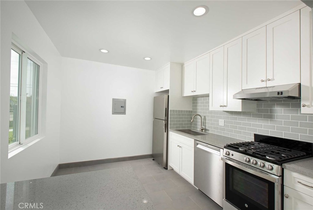 5459 Carlin Street, Unit 1 Los Angeles, CA 90016 - Photo 15 of 22 a kitchen with stainless steel appliances granite countertop a stove a sink and a refrigerator