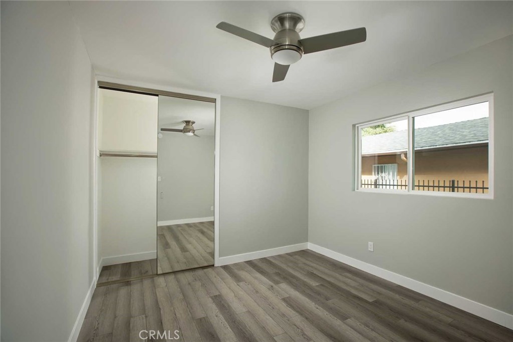 5459 Carlin Street, Unit 1 Los Angeles, CA 90016 - Photo 20 of 22 an empty room with wooden floor and windows