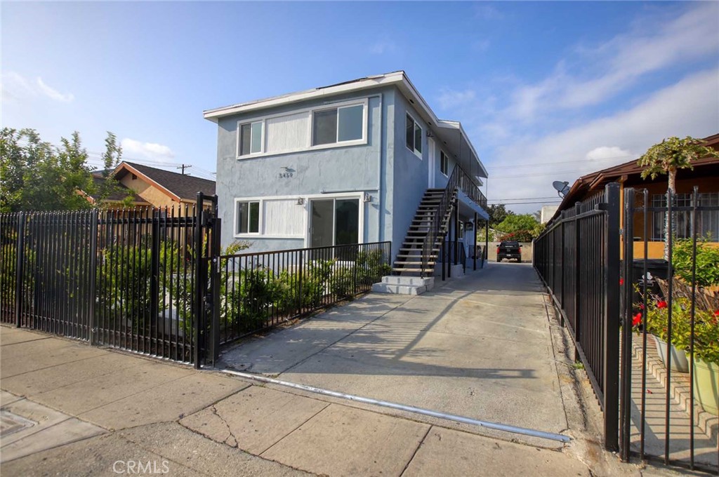 5459 Carlin Street, Unit 1 Los Angeles, CA 90016 - Photo 2 of 22 a front view of a house with a garden